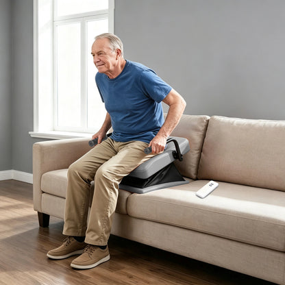 Adult man using a WHLICKS gray electric chair lift assist cushion on a sofa during a sit-to-stand transition at home.